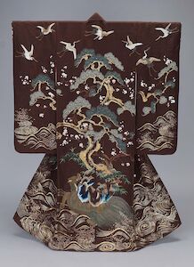 A kimono featuring pine trees and cranes on the back of a large turtle.