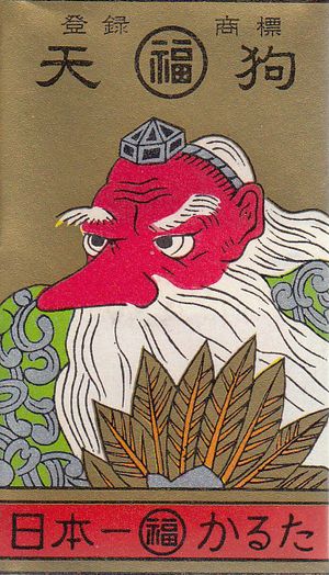 A Hanafuda wrapper featuring a red figure with a big nose, holding a fan made of feathers.