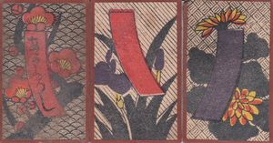 Three hanafuda cards: the first, with a red ribbon with writing on it, has a background consisting of a wave pattern, the second, with a red ribbon without writing, has a diagonal-striped background, and the third, with a blue ribbon, has a hatched background.
