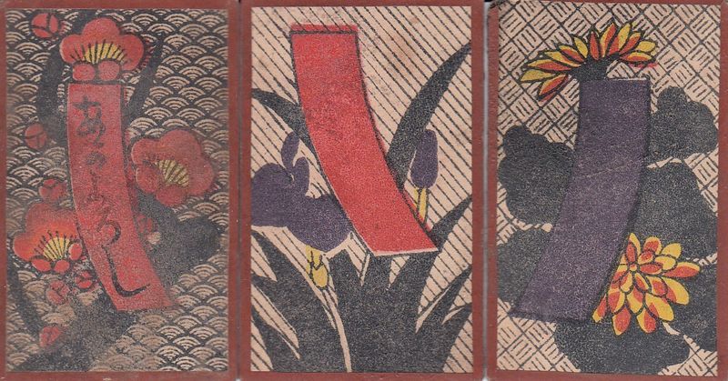 Three hanafuda cards: the first, with a red ribbon with writing on it, has a background consisting of a wave pattern, the second, with a red ribbon without writing, has a diagonal-striped background, and the third, with a blue ribbon, has a hatched background.