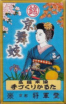 A hanafuda wrapper with a depiction of an apprentice geisha under blossoms and autumn leaves.