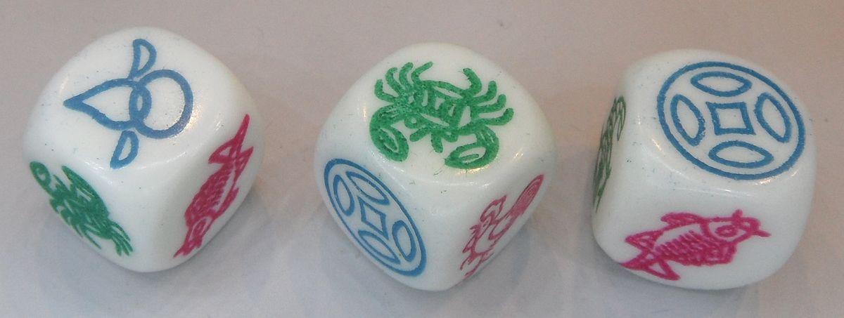 Three dice bearing the Chinese symbols: fish, prawn, crab, gourd, coin, and rooster.