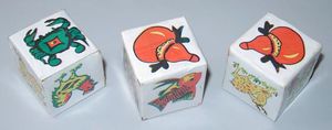 Three dice made out of paper boxes with the images of the Vietnamese version of the game on them.