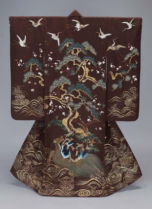A kimono featuring pine trees and cranes on the back of a large turtle.