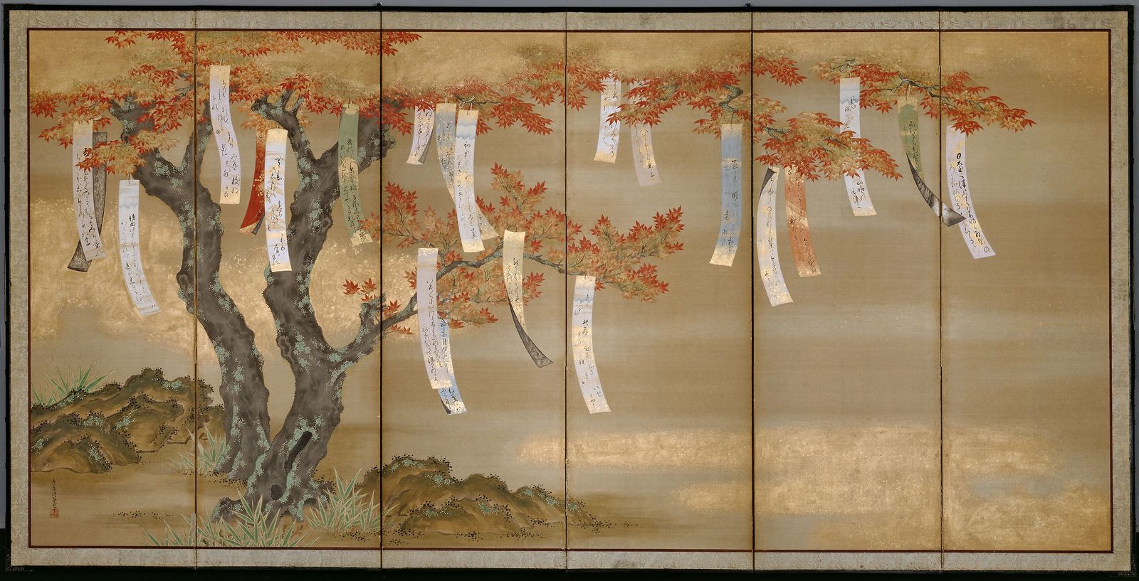 A screen with a painting of a maple tree in autumn colours, and many tanzaku hanging from its branches.