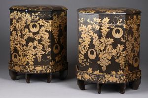 Two large octagonal wooden containers painted with black lacquer and gold ornamental designs of wisteria.