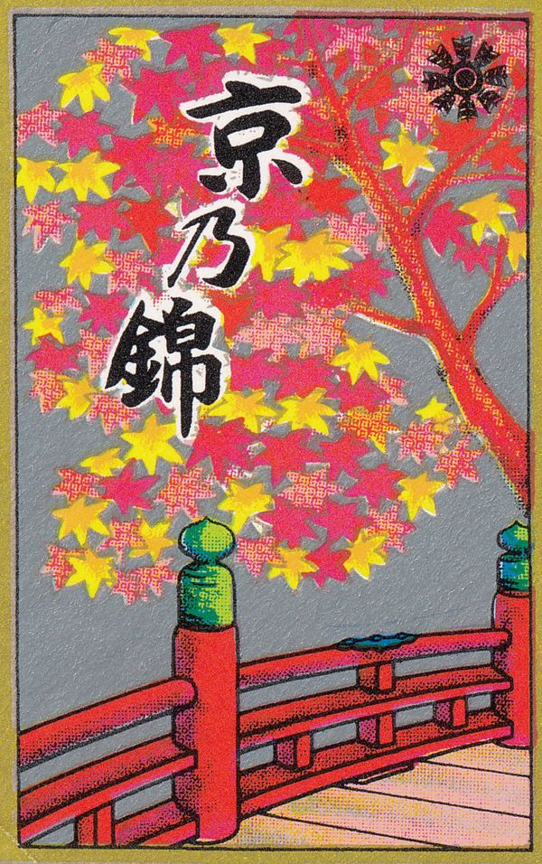 A hanafuda wrapper with a bridge and overhanging maple leaves in autumn colours.